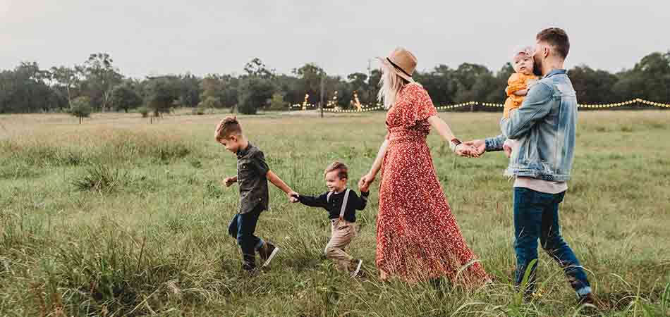 Family relaxing in a field | managing stress and anxiety