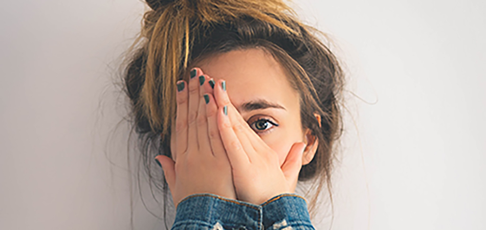 Young woman worrying how to get rid of spots